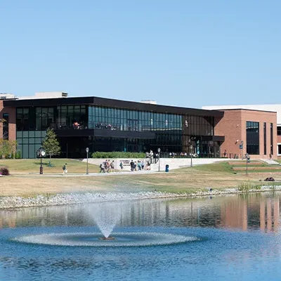 Outside of Scharnberg Business and Communication Center with lake and fountain in foreground.